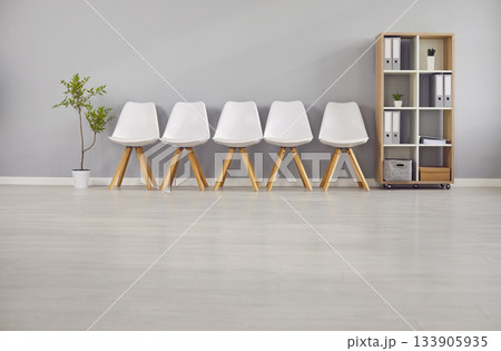 Minimalistic Row of Empty White Chairs at Office 133905935