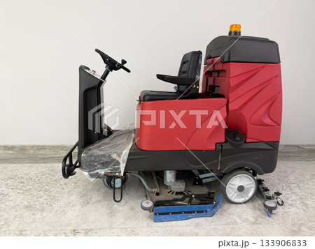 Compact vacuum sweeper with stationary operator seat Professional equipment for cleaning shopping mall floors. Electric machine with brushes for wiping floors 133906833