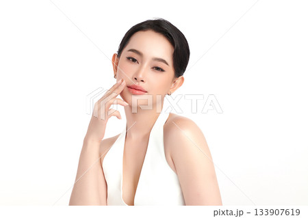A beautiful young Asian woman with clean, fresh skin against a white background. Skincare, facial treatment, cosmetology, beauty, and spa. An elegant portrait of an Asian woman. A beautiful young Asian woman with clean, fresh skin against a white background. Skincare, facial treatment, cosmetology, beauty, and spa. An elegant portrait of an Asian woman. 133907619