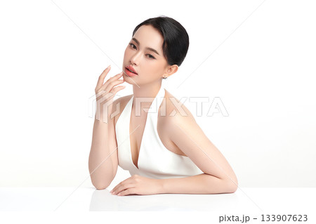 A beautiful young Asian woman with clean, fresh skin against a white background. Skincare, facial treatment, cosmetology, beauty, and spa. An elegant portrait of an Asian woman. A beautiful young Asian woman with clean, fresh skin against a white background. Skincare, facial treatment, cosmetology, beauty, and spa. An elegant portrait of an Asian woman. 133907623