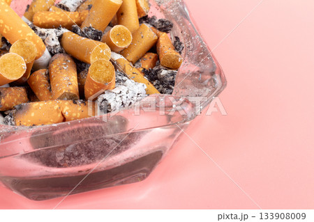 cigarette butts torn on pink background ashtray 133908009