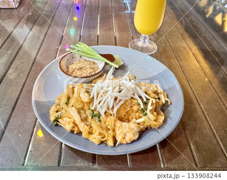 Delicious fresh Thai pad thai with chicken in an outdoor cafe 133908244