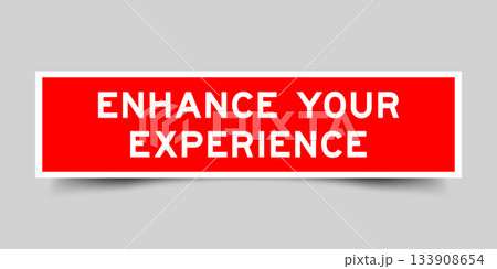 Red color square shape sticker label with word enhance your experience on gray background Red color square shape sticker label with word enhance your experience on gray background 133908654