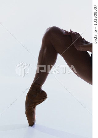 Close-up of ballerina leg stretched forward in pointe position 133909007