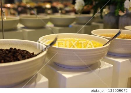 Displaying seven colorful cereal bowls clustered on wooden table, showing milk jar and icons. Flatlay, breakfast, assortment, bowl, grains, kitchen, cozy Displaying seven colorful cereal bowls clustered on wooden table, showing milk jar and icons. Flatlay, breakfast, assortment, bowl, grains, kitchen, cozy 133909072