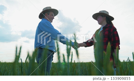 Professional agreement at farm, Farmers meeting at sunrise, Business concluded in nature, Partnership handshake in rural area, Agricultural work friendship, Wheat field cooperation, Rural handshake 133909855