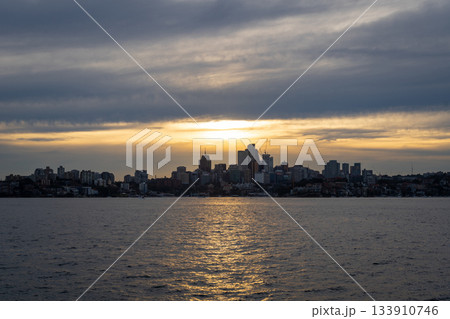 Sydney skyline at sunset with golden reflections on the water Sydney skyline at sunset with golden reflections on the water 133910746
