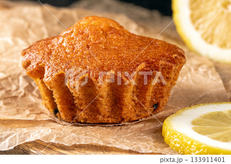 Golden lemon muffin with juicy lemon slices on a charming kitchen table 133911401