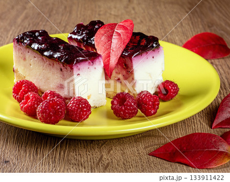 Delicious pastries filled with raspberry jam and fresh raspberries on a plate 133911422