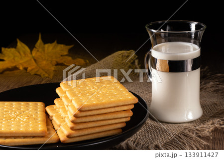A cozy kitchen scene featuring milk and crackers for a comforting snack time 133911427