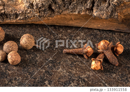 Close-up of colorful peppercorns and cloves on a black background 133911558