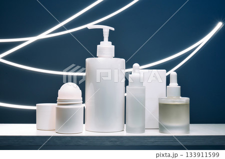 Skincare cosmetic products with serum and light trails Skincare cosmetic products with serum and light trails 133911599