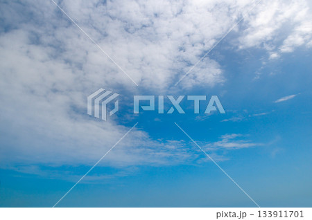 Bright Blue Sky Background with White Cirrocumulus and Stratus Clouds 133911701