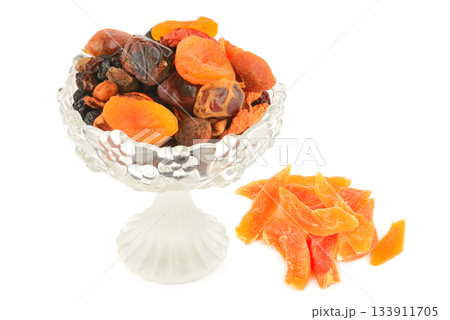 Dried Apricots, Dates, and Candied Fruit in a Glass Vase on White 133911705
