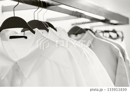 White and gray shirts on hangers in fashion store. Color of the year concept 133911830