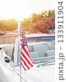 American flag on antenna of an American vintage car during US Independence day celebration on street 133911904