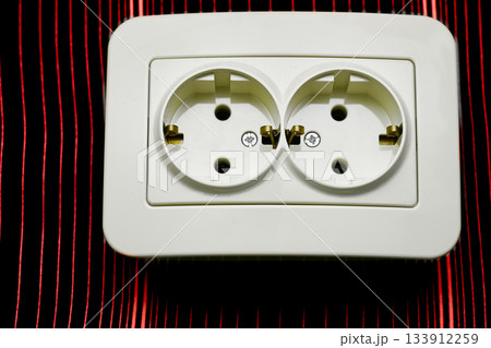Double electrical plug socket for connecting devices on shiny red 133912259