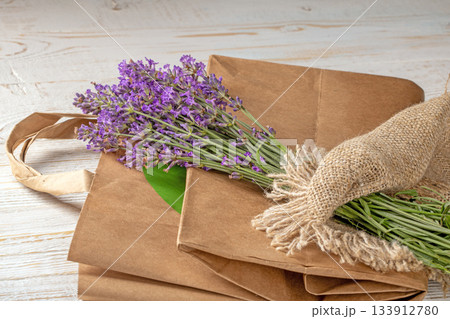 A beautiful lavender bouquet resting on an eco-friendly shopping bag A beautiful lavender bouquet resting on an eco-friendly shopping bag 133912780