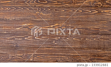 Natural high-contrast background of brown weathered wooden boards Natural high-contrast background of brown weathered wooden boards 133912881