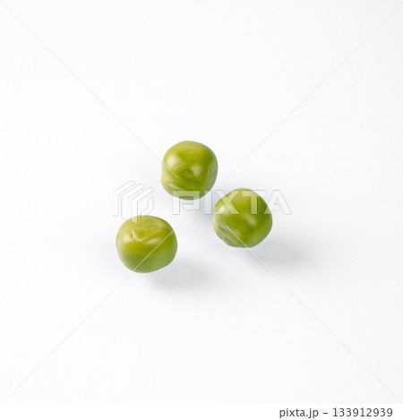 Close-up of three fresh green peas on a clean white background Close-up of three fresh green peas on a clean white background 133912939