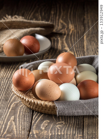 Sustainable farm-raised chicken eggs beautifully arranged on wooden table Sustainable farm-raised chicken eggs beautifully arranged on wooden table 133912949
