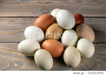 Fresh, environmentally friendly chicken eggs on a rustic wooden table from a home farm Fresh, environmentally friendly chicken eggs on a rustic wooden table from a home farm 133912959