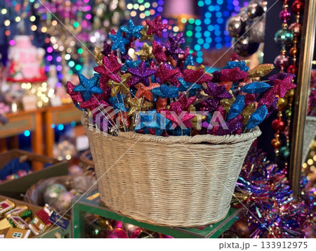 Christmas Wicker basket filled with glitter star picks in bright holiday colors. Festive creative decor, Christmas craft charm, joyful winter celebration and magical party inspiration. Christmas Wicker basket filled with glitter star picks in bright holiday colors. Festive creative decor, Christmas craft charm, joyful winter celebration and magical party inspiration. 133912975