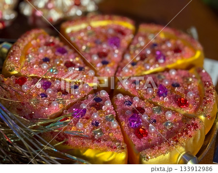Christmas bauble Glitter pizza slices covered with gems and beads as decorative Christmas piece. Celebration fun, creative holiday styling, whimsical festive accents and joyful seasonal sparkle. 133912986