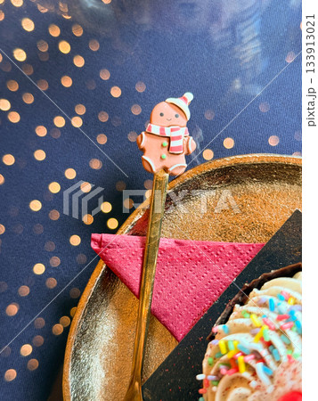 Christmas Gingerbread spoon resting beside a festive dessert. Playful celebration, joyful tradition and warm winter storytelling shaping cheerful holidays mood and charming seasonal atmosphere Christmas Gingerbread spoon resting beside a festive dessert. Playful celebration, joyful tradition and warm winter storytelling shaping cheerful holidays mood and charming seasonal atmosphere 133913021