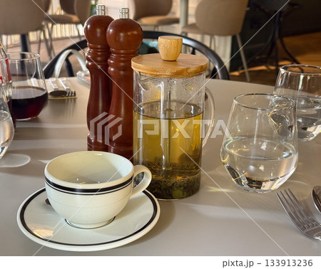 Morning tea on a cozy cafe table. Calm routine, relaxation, and slow living captured through simple still life and natural light. Morning tea on a cozy cafe table. Calm routine, relaxation, and slow living captured through simple still life and natural light. 133913236