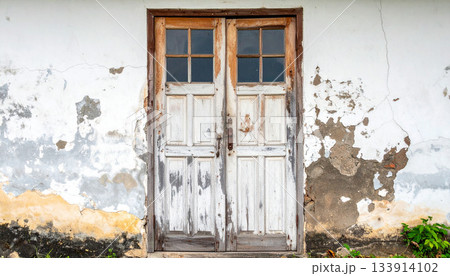 Weathered Double Doors in Old Building Facade Weathered Double Doors in Old Building Facade 133914102