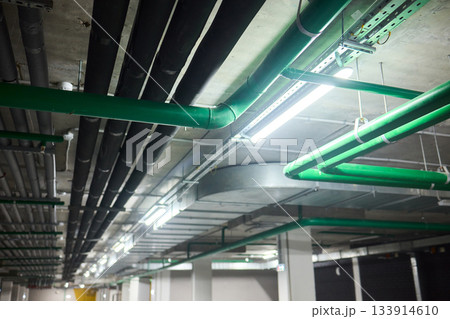 Subterranean parking details, Basement parking area equipped with lighting and plumbing, Underground vehicle shelter featuring electrical wiring and ventilation systems Subterranean parking details, Basement parking area equipped with lighting and plumbing, Underground vehicle shelter featuring electrical wiring and ventilation systems 133914610