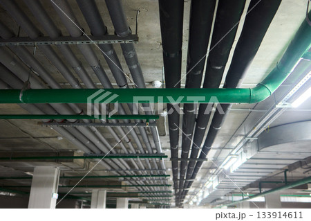 Subterranean parking details, Basement parking area equipped with lighting and plumbing, Underground vehicle shelter featuring electrical wiring and ventilation systems Subterranean parking details, Basement parking area equipped with lighting and plumbing, Underground vehicle shelter featuring electrical wiring and ventilation systems 133914611