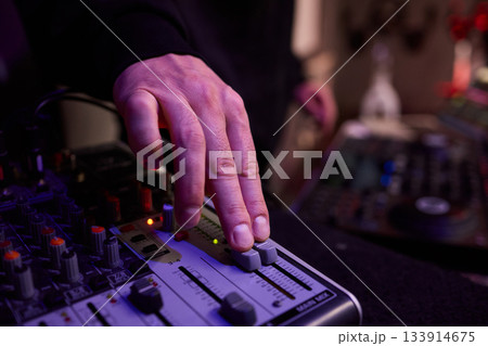Closeup of tactile controls and vibrant patch cords in studio, Adjusting analog sequencing equipment with bright cables and warm ambient lighting in home studio Closeup of tactile controls and vibrant patch cords in studio, Adjusting analog sequencing equipment with bright cables and warm ambient lighting in home studio 133914675