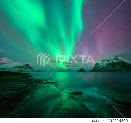 Aurora borealis on night starry sky with green and pink colors Aurora borealis on night starry sky with green and pink colors 133914806