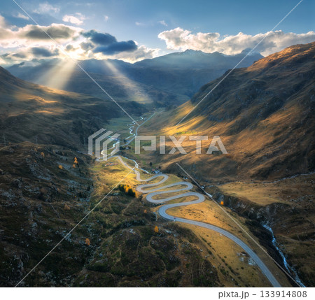 Aerial view of winding mountain road in the Swiss Alps at sunset Aerial view of winding mountain road in the Swiss Alps at sunset 133914808
