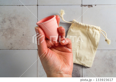 Menstrual cup. Pink feminine hygiene product. Women health concept. Menstrual cup. Pink feminine hygiene product. Women health concept. 133915617