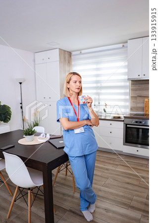 Female Doctor Drinking Coffee During Work Break at Home Female Doctor Drinking Coffee During Work Break at Home 133915915