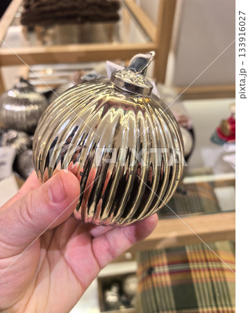 Unique silver ornament held in hand, showcasing beauty and craftsmanship Unique silver ornament held in hand, showcasing beauty and craftsmanship 133916027