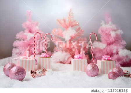 Pink Winter Wonderland. A festive scene with pink trees, gifts, and candy canes Pink Winter Wonderland. A festive scene with pink trees, gifts, and candy canes 133916388