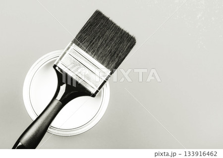 Paint brush resting on white paint can monochrome. Color of 2026 year dancer in the white cloud 133916462