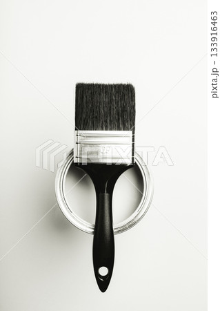 Paintbrush resting on open paint can in black and white. Color of 2026 year dancer in the white cloud 133916463