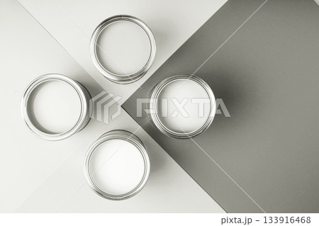 White paint cans on a gray geometric background. Color of 2026 year dancer in the white cloud White paint cans on a gray geometric background. Color of 2026 year dancer in the white cloud 133916468