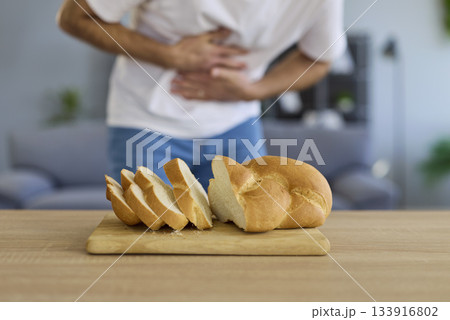 Gluten allergy, food intolerance of man holding belly, suffering from stomach pain Gluten allergy, food intolerance of man holding belly, suffering from stomach pain 133916802