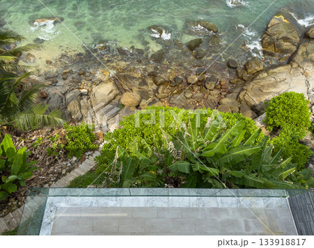 stone staircase leading through tropical trees to the sea and rocky coast, balcony, palm trees, surf, azure water, nobody, no people 133918817