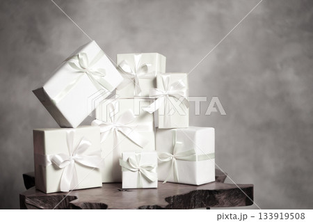 White gift boxes with ribbons as a celebration stack. Color of 2026 year dancer in the white cloud White gift boxes with ribbons as a celebration stack. Color of 2026 year dancer in the white cloud 133919508