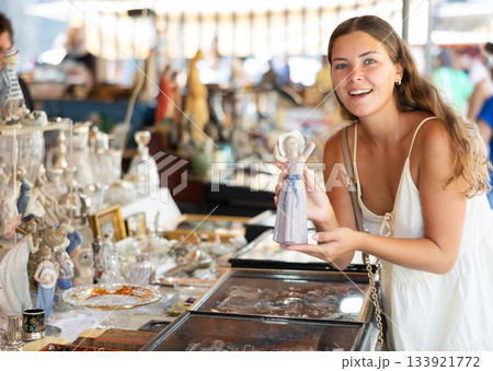 Female traveler buyer chooses ceramic antiquarian porcelain shepherdess Female traveler buyer chooses ceramic antiquarian porcelain shepherdess 133921772