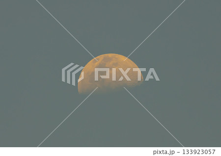 An orange moon during the rising phase in mid afternoon 133923057