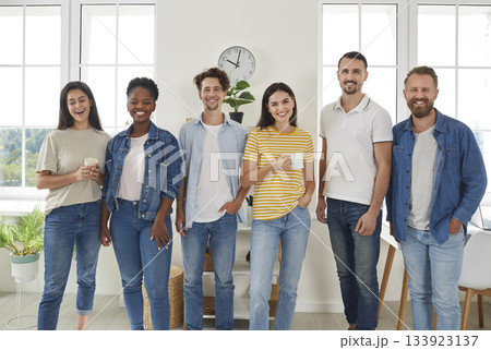 Group of multiracial young people standing in row posing for photo Group of multiracial young people standing in row posing for photo 133923137