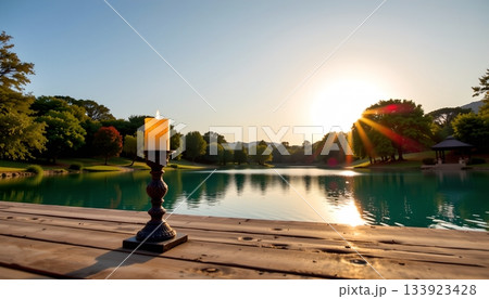 A serene outdoor setting, featuring a wooden deck with a large glass surface that reflects the sky A serene outdoor setting, featuring a wooden deck with a large glass surface that reflects the sky 133923428